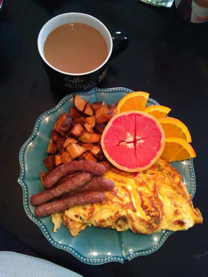Cheese omelette with home fries fresh fruit and side of sausage